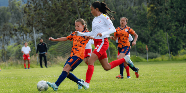 Girls playing soccer.